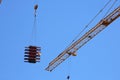 Machinery crane hoisting up steel rod bar in construction