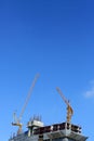 Machinery crane working in construction site building Royalty Free Stock Photo