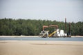 Machinery factory working sand suction dredger in sea and ocean at Samila Beach in Hat Yai of Songkhla, Thailand