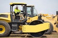 machinery in a industry with hispanic construction worker. construction worker used heavy machinery. construction