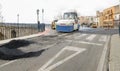 Machines performing asphalting and paving work on a city road.