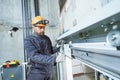 Machinist with spanner adjusting lift mechanism in elevator shaft Royalty Free Stock Photo