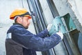 Machinist with spanner adjusting lift mechanism in elevator shaft Royalty Free Stock Photo