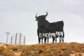 `Machismo kills` writing on a big shield shaped like a bull in Spain