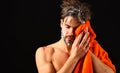 Macho attractive nude guy black background. Man bearded tousled hair covered with foam or soap suds. Wash off foam with