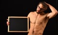 Macho attractive nude guy hold blackboard. Man smart and with beard and tousled hair wears eyeglasses. Man
