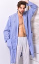 Macho in bathrobe with strong chest and six packs. Royalty Free Stock Photo