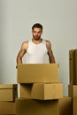 Macho with beard and concentrated face holding box