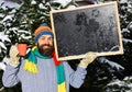 Macho with beard holds cup and blackboard with frost on