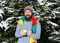 Macho with beard and mustache plays with snowball. Royalty Free Stock Photo