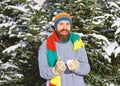 Macho with beard and mustache plays with snowball. Royalty Free Stock Photo