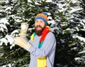 Macho with beard and mustache plays with snowball. Royalty Free Stock Photo