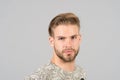 Macho with bearded face, beard. Man with blond hair, haircut. Grooming and hair care in beauty salon, barbershop. Fashion, style a