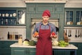 Macho in chef hat, apron with red and orange pepper Royalty Free Stock Photo