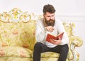 Macho on concentrated face reading book. Scandalous bestseller concept. Guy reading book with attention. Man with beard Royalty Free Stock Photo