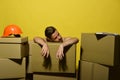 Macho with exhausted face has helmet and folder. Royalty Free Stock Photo