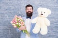 Macho getting ready romantic date. Waiting for darling. Man well groomed wear tuxedo bow tie hold flowers tulips bouquet Royalty Free Stock Photo