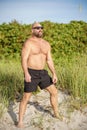 Macho guy on the beach with sunglasses on the weekend Royalty Free Stock Photo