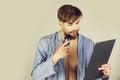 Macho looking at mirror and shaving beard with shaver Royalty Free Stock Photo