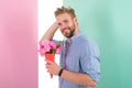Macho holds bouquet as romantic gift. Guy bring romantic pleasant gift waiting for her. Man ready for date bring pink Royalty Free Stock Photo