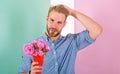 Macho holds bouquet as romantic gift. Guy bring romantic pleasant gift waiting for her. Man ready for date bring pink Royalty Free Stock Photo