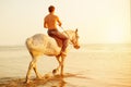 Macho man and horse on the background of sky and water. Boy mode Royalty Free Stock Photo