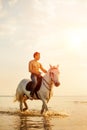 Macho man and horse on the background of sky and water. Boy mode Royalty Free Stock Photo