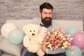 Macho ready romantic date. Man wear blue tuxedo bow tie hold flowers bouquet. Romantic man with flowers and teddy bear