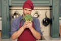 Macho in red chef hat, apron hold green broccoli Royalty Free Stock Photo