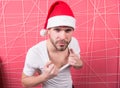 Macho in red xmas hat on pink background Royalty Free Stock Photo