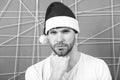 Macho in santa hat touch beard on serious face Royalty Free Stock Photo