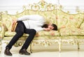 Macho sleep with book in hand. Boring literature concept. Man with beard and mustache lay on baroque style sofa, holds Royalty Free Stock Photo
