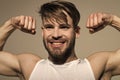 Macho smile with strong arms in white singlet