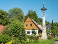 Machovska Lhota, Czechia. Small historical bell tower and typical wooden house