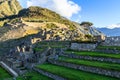 Machu Picchu green terraces and ruins with mountains in the back Royalty Free Stock Photo