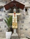 Clerical Garments over a stone cross outside The Parroquia Virgen del Carmen Church.
