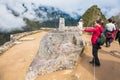 Tourist in front of Intihuatana stone, sacred valley, Cusco region, Peru