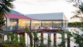 People Dining At Waterfront Restaurant At Sunset