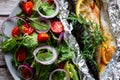 Mackerel baked in foil with vegetables on a plate. Royalty Free Stock Photo