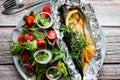 Mackerel baked in foil with vegetables on a plate. Royalty Free Stock Photo