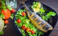 Mackerel baked with lemon. Fish on a plate with vegetables Royalty Free Stock Photo