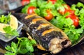 Mackerel baked with lemon. Fish on a plate with vegetables Royalty Free Stock Photo