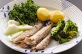 Mackerel fish dish with potatoes, broccoli, onions and parsley. Fatty, oily fish is an excellent and healthy source Royalty Free Stock Photo