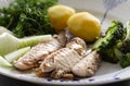 Mackerel fish dish with potatoes, broccoli, onions and parsley. Fatty, oily fish is an excellent and healthy source Royalty Free Stock Photo