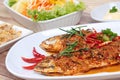 Mackerel fish fried topped spicy curry with side dish. Selective focus. Royalty Free Stock Photo