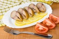 Mackerel, slices of lemon in dish, pieces of tomatoes Royalty Free Stock Photo