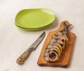 Mackerel smoked chopped to pieces on a cutting board on the kitchen table Royalty Free Stock Photo