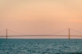 The Mackinac Bridge standing tall in Lake Michigan at sunset Royalty Free Stock Photo