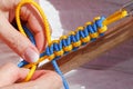 Macrame, lace on the wooden background.