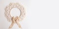 Macrame mandala. Macrame christmas wreath on a white background close up. Natural cotton thread. Eco home decor. Banner. Copy